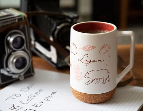 mug with bear and acorn logos on it