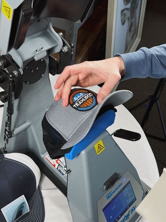 staff holding patched custom made hat