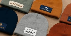 many beanies laid out on table