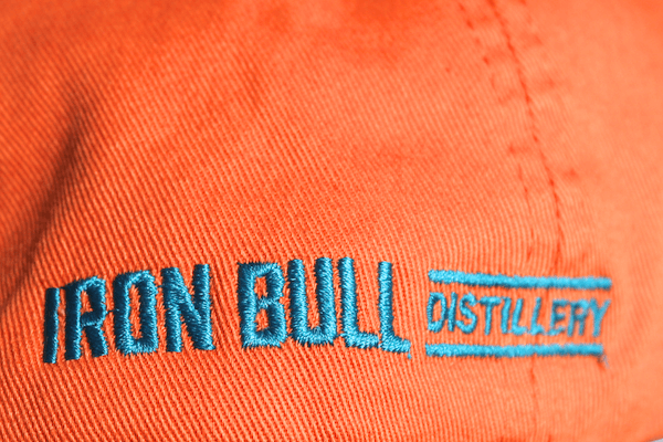 blue embroidery on the side of orange cap